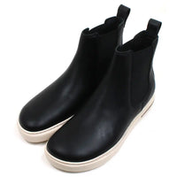 Birkenstock Bend Chelsea boots in black with cream coloured soles. Elasticated ankle side panels. Pull tabs at the back. Angled view.