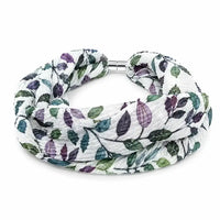 A double-strand infinity scarf with a white background and a leaf pattern in shades of green and purple, featuring a silver metal clasp.