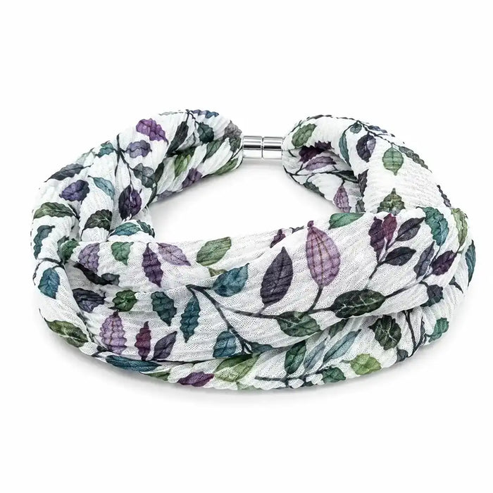 A double-strand infinity scarf with a white background and a leaf pattern in shades of green and purple, featuring a silver metal clasp.