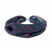 A dark gray ribbed fabric headband with a pink polka dot pattern and a silver metal clasp, shown on a plain white background.