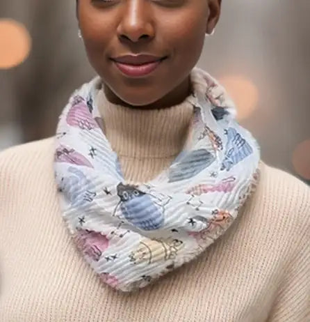 White ribbed scarf with pastel multicoloured cats on it. 