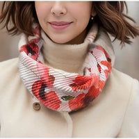 Person wearing a colorful scarf with a neutral background