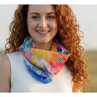 Woman wearing a colorful scarf with a blurred natural background