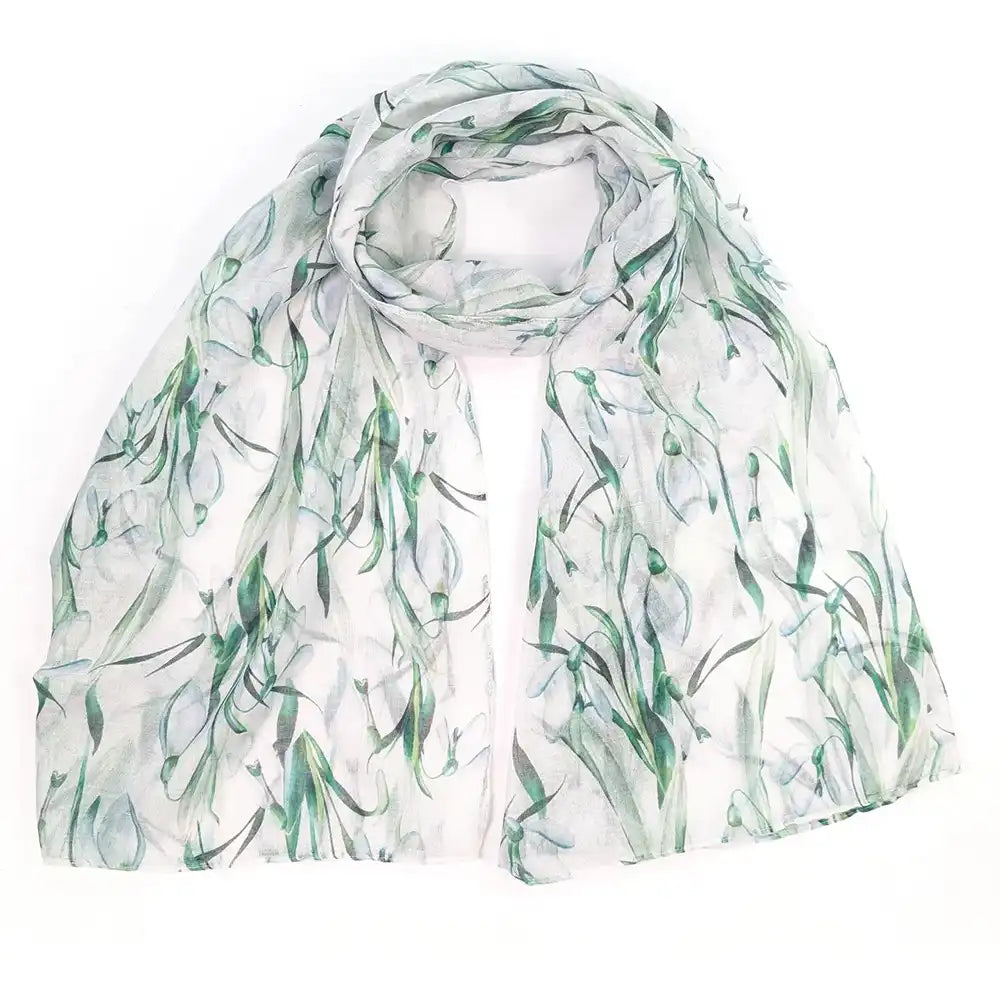 A lightweight white scarf with a watercolor-style green botanical print, draped and folded on a plain white background.
