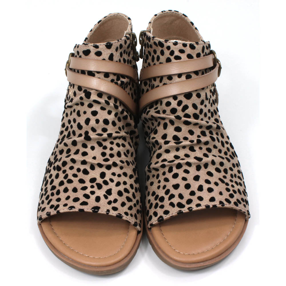 Blowfish Malibu open toes and sides, foot covering sandals. Sand coloured leopard print. Two straps over the upper foot. Front view.