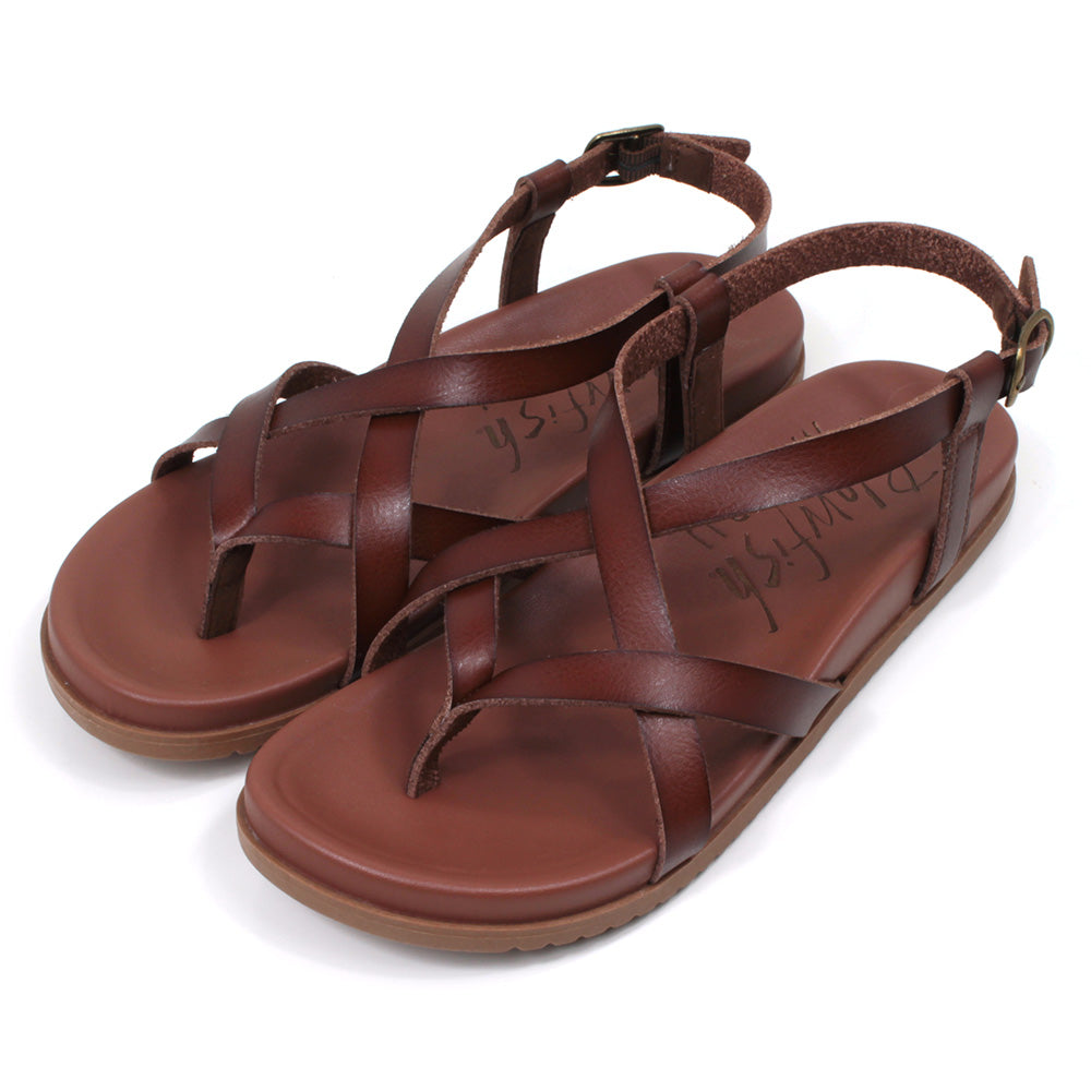 Blowfish Malibu strappy sandals in brown. Toe post style. Metal buckles for adjusting ankle straps. Angled view.