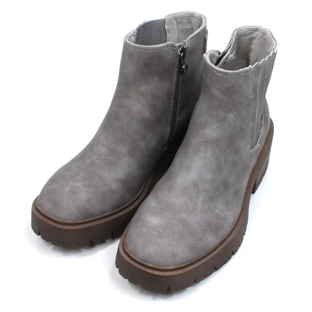 Blowfish Malibu grey faux suede zip up Chelsea boots with rugged dark brown soles. Elastic panel hidden behind leaved faux suede. Angled view.