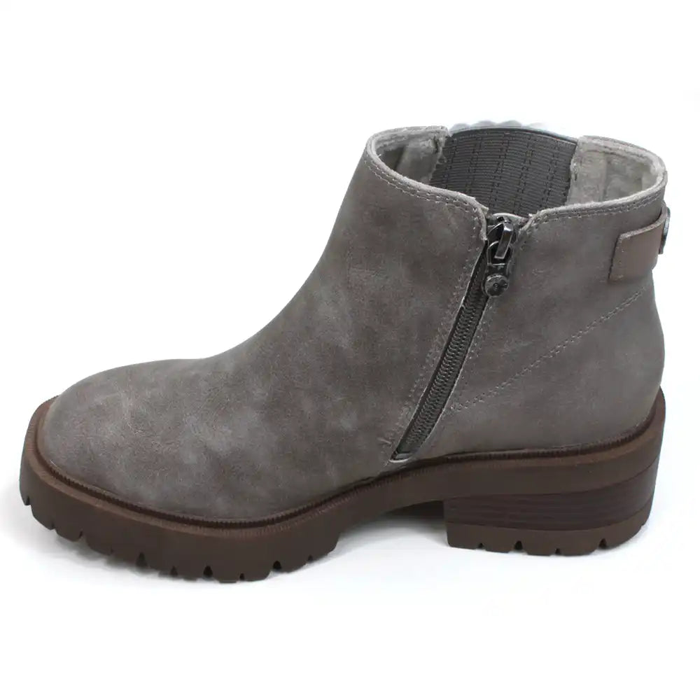 Blowfish Malibu grey faux suede zip up Chelsea boots with rugged dark brown soles. Elastic panel hidden behind leaved faux suede. View of single boot showing zip fastening.