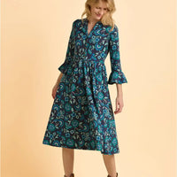 Woman wearing a blue floral dress on a beige background