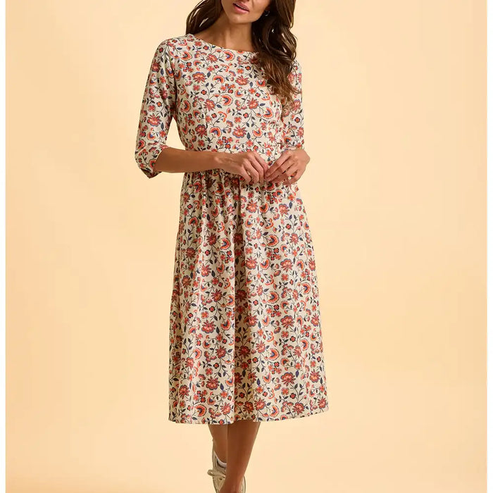 Woman wearing a floral dress on a beige background