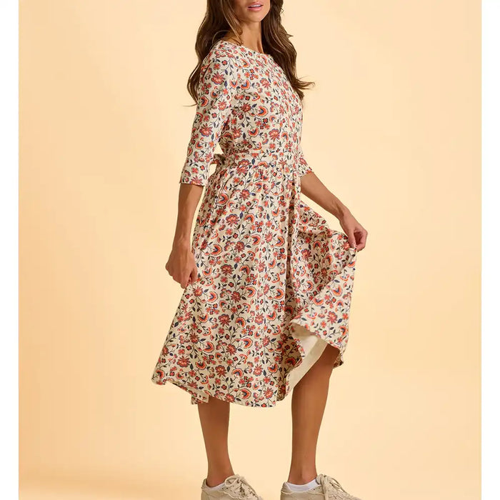 Woman wearing a floral dress on a beige background