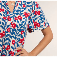 Close-up of a floral dress with red and blue flowers on a white background