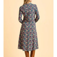 Floral dress worn by a person on a beige background