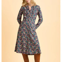 Woman wearing a floral dress on a beige background