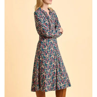 Floral dress worn by a model on a beige background