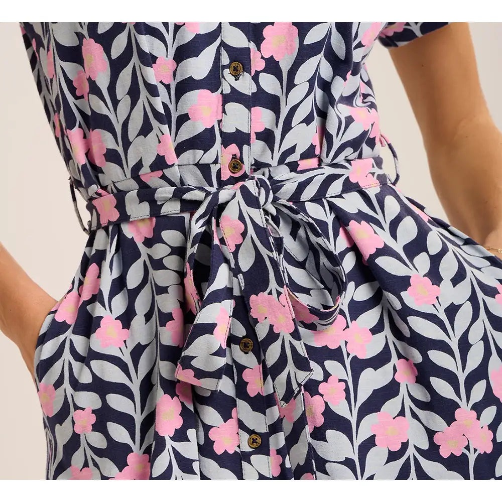 Navy blue dress with pink floral pattern on a plain background