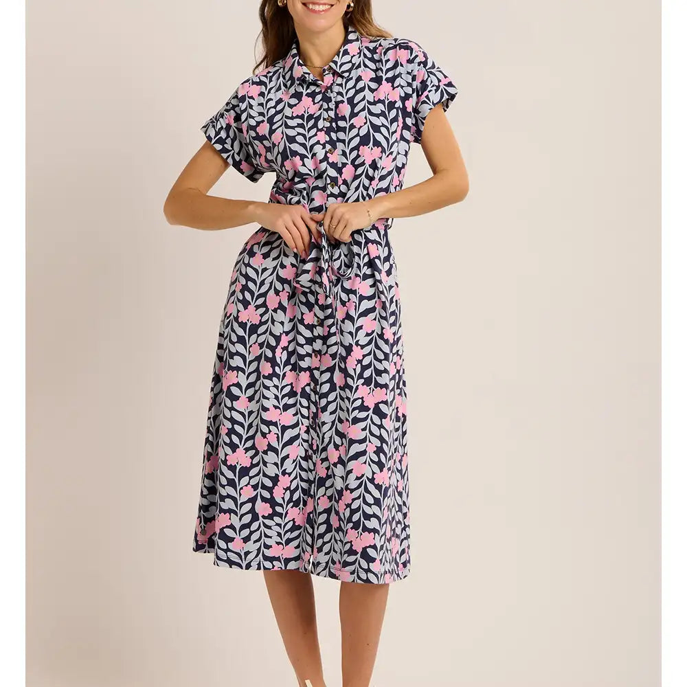 Woman wearing a patterned dress on a beige background