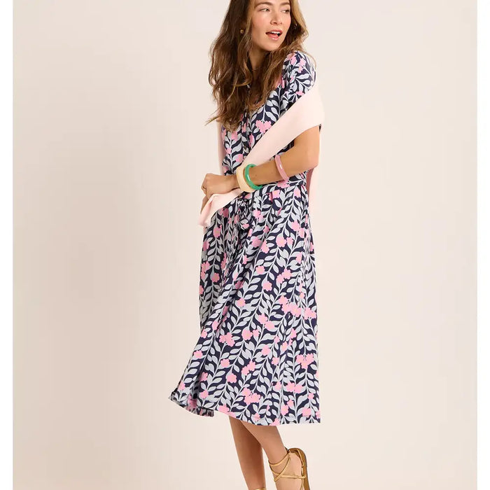 Woman wearing a patterned dress on a beige background