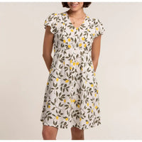 Front of a white dress with yellow lemons and green leaves. 