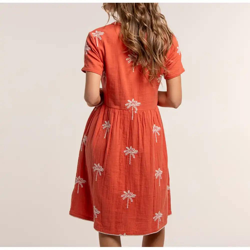 Orange dress with white floral patterns on a plain background