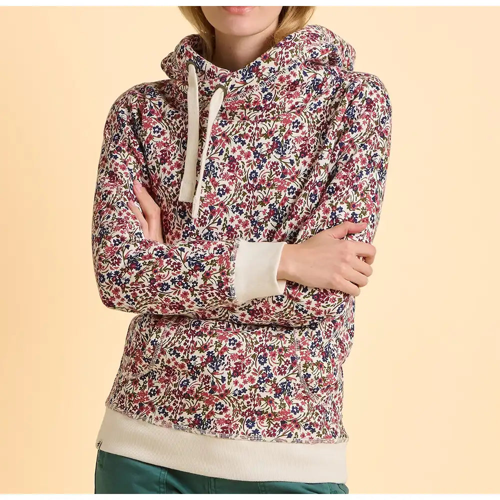 Floral patterned hoodie worn by a person on a beige background