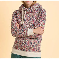 Floral patterned hoodie worn by a person on a beige background