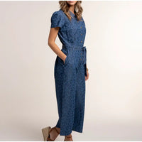 Woman wearing a blue lace dress on a beige background