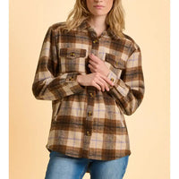 Woman wearing a plaid shirt and jeans on a beige background