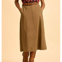 Brown skirt worn by a person on a beige background