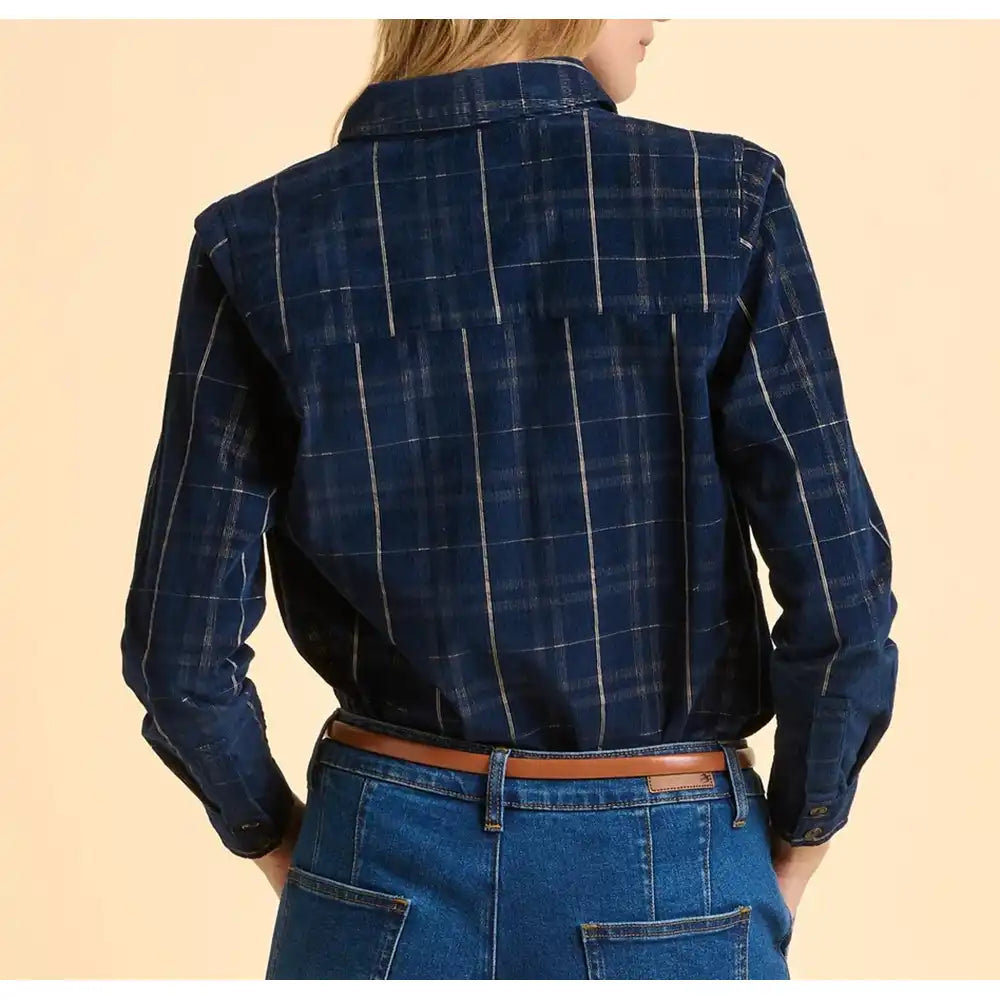 Person wearing a blue plaid shirt and jeans on a beige background