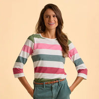Woman wearing a colorful striped shirt against a beige background