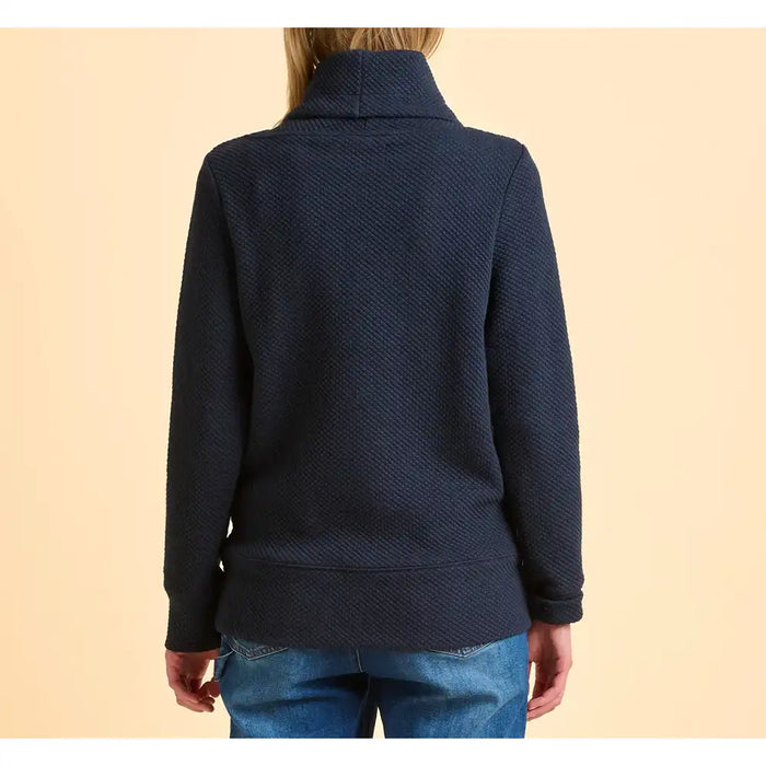 Navy blue sweater worn by a person on a beige background