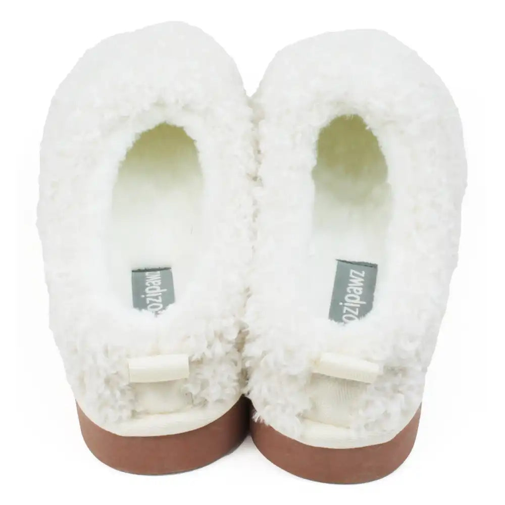 Pair of white fluffy slippers with brown soles on a white background