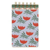 Notebook with red floral pattern on a light blue background