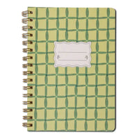 Notebook with green geometric pattern on a white background