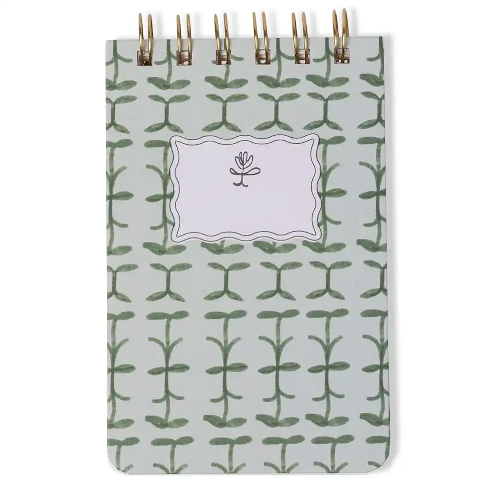 Notebook with green leaf pattern on a white background
