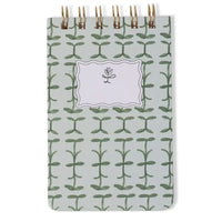 Notebook with green leaf pattern on a white background