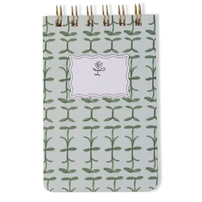 Notebook with green leaf pattern on a white background