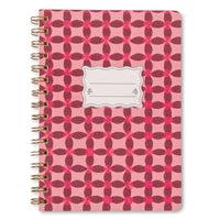 Notebook with pink and red geometric pattern on a white background