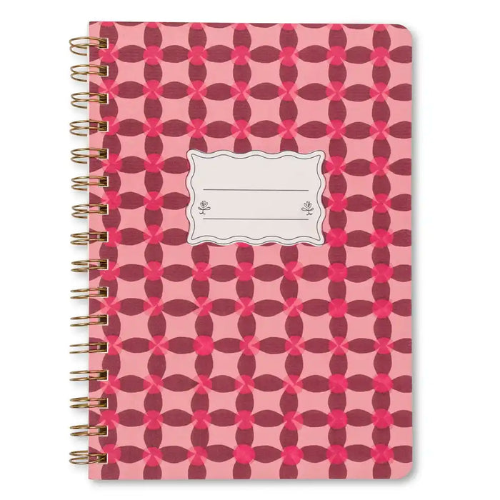 Notebook with pink and red geometric pattern on a white background