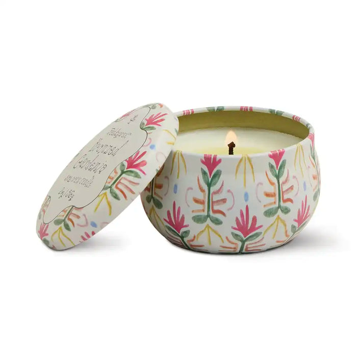 Lidded floral patterned tin containing candle