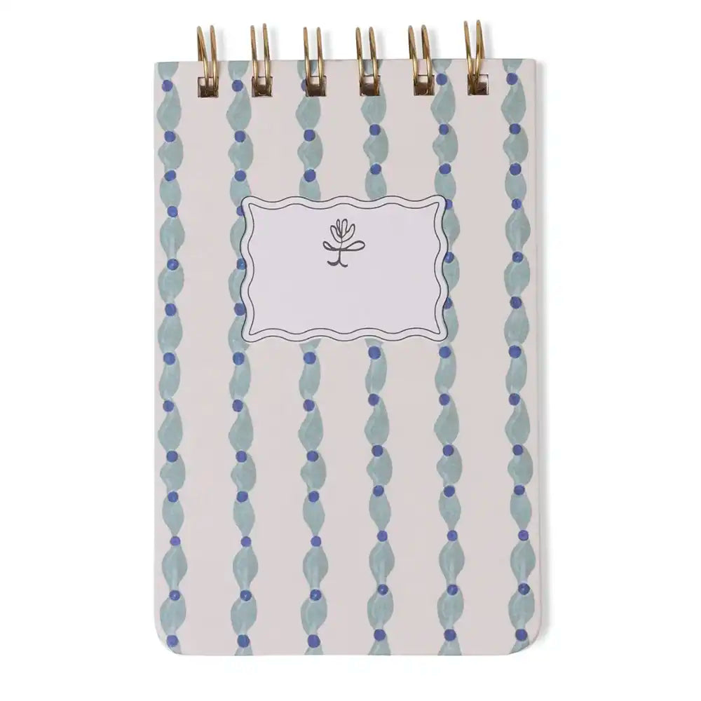 Notebook with decorative cover featuring vertical blue and gray pattern on a white background
