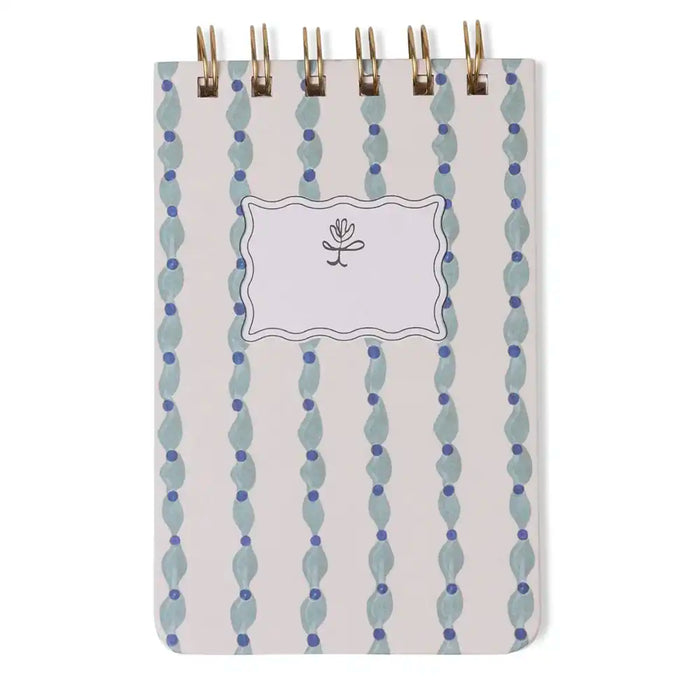 Notebook with decorative cover featuring vertical blue and gray pattern on a white background