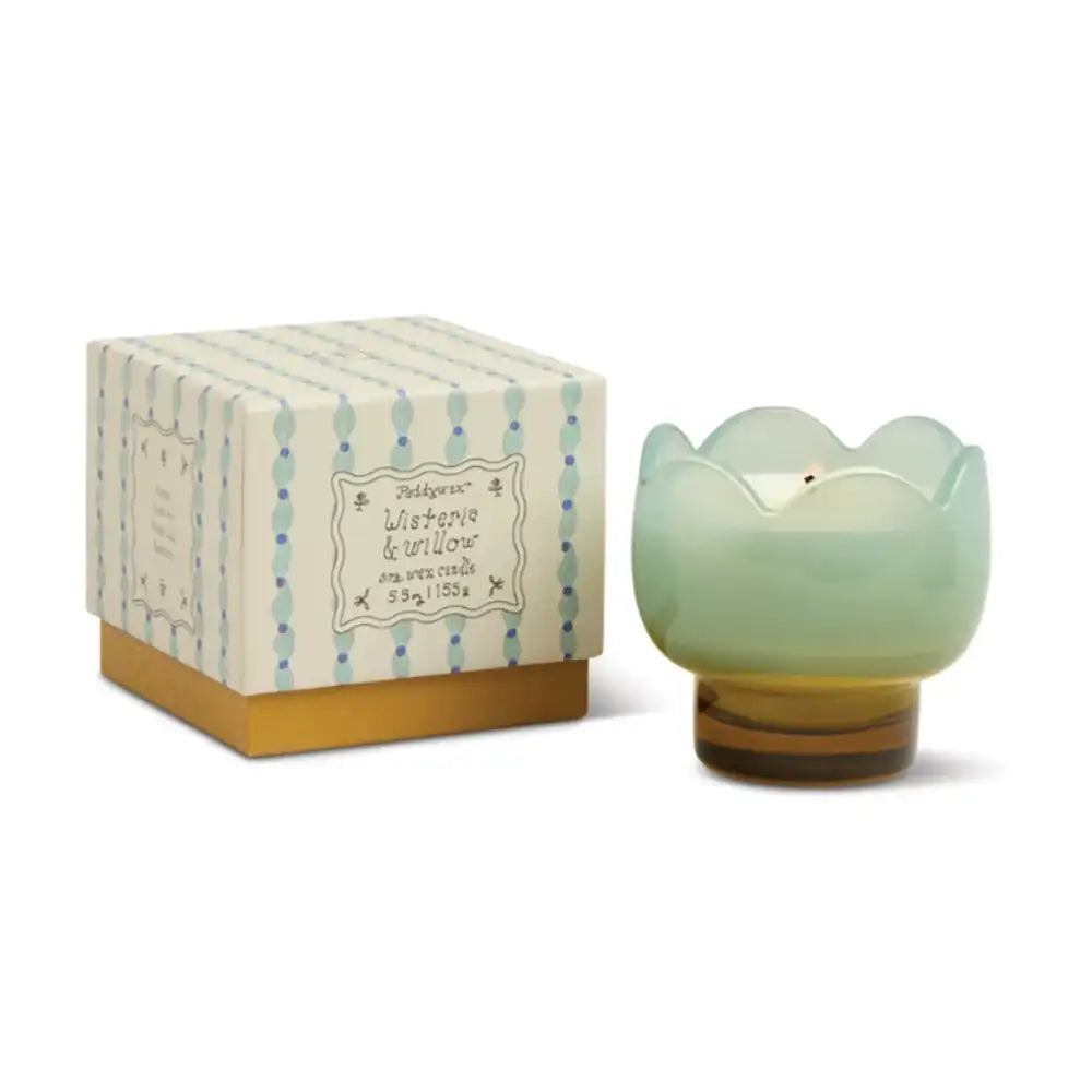 Light green candle in a decorative box on a white background