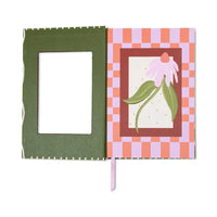 Front of notebook with painted coneflower surrounded by lilac and orange squares. Cut out frame front cover open 