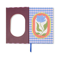 Notebook with a floral design on the cover against a white background