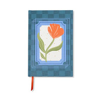 Blue notebook with a red flower illustration on a white background
