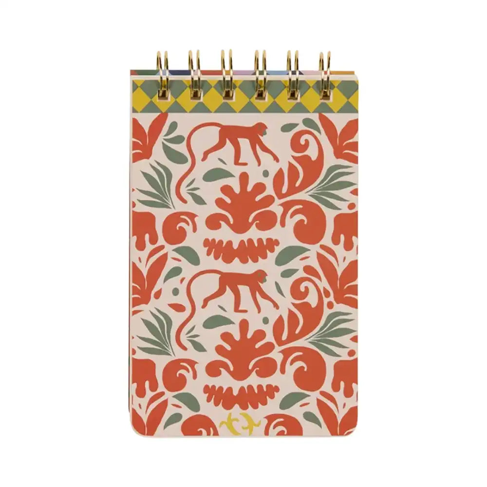 Note book with wire binding at the top. Has red monkey motifs and green leaf motifs on it