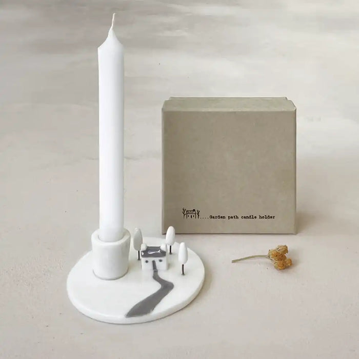 East of India white porcelain candle holder. House and trees sculpted scene on the base. White pillar candle. Presentation box. 