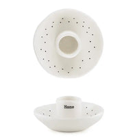 White ceramic holder with small bowl on a white background